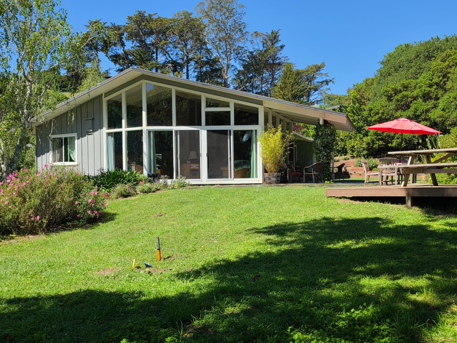 The main house on the property — a real home with a yard and garden
